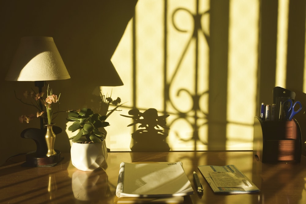 a desk with a lamp and a book on it