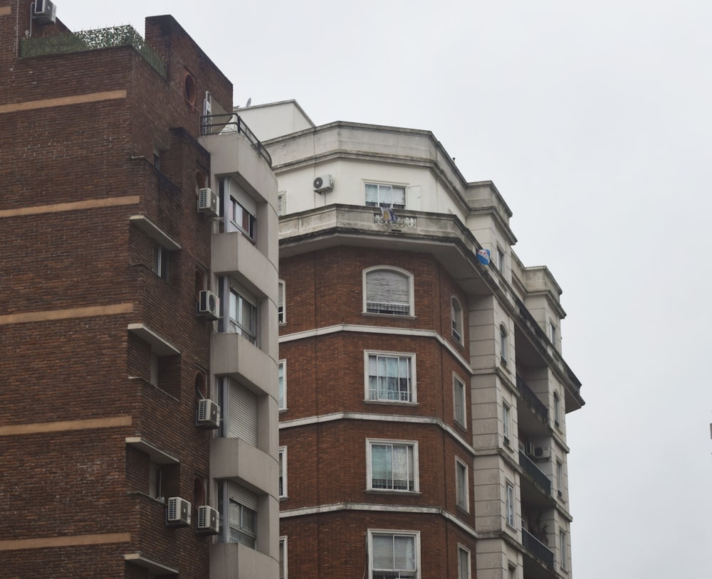 a tall brick building with a clock on the top of it