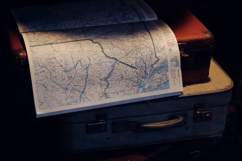 a map sitting on top of a piece of luggage