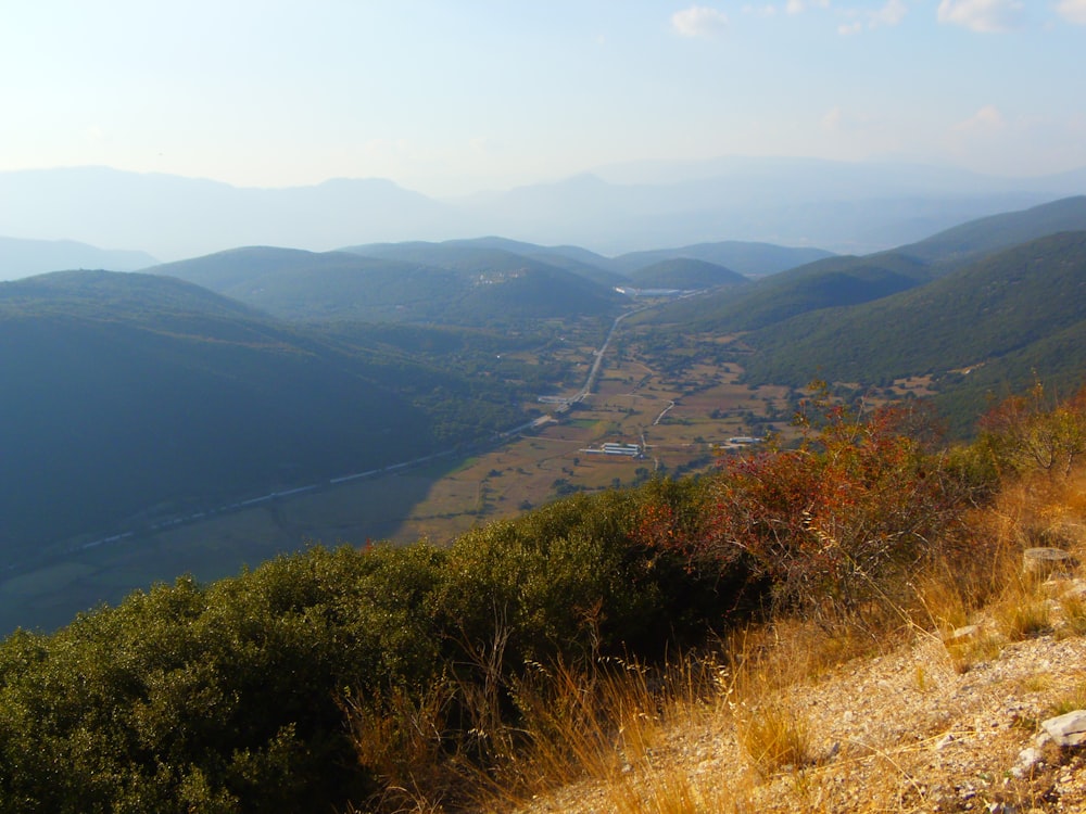 a view of a valley with a river running through it