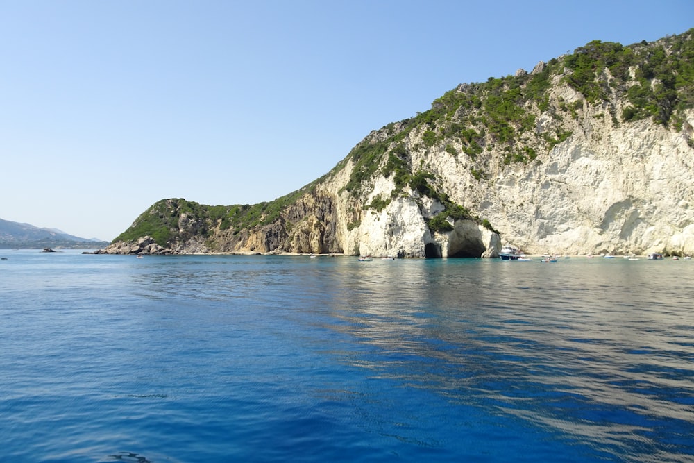 a body of water with a mountain in the background