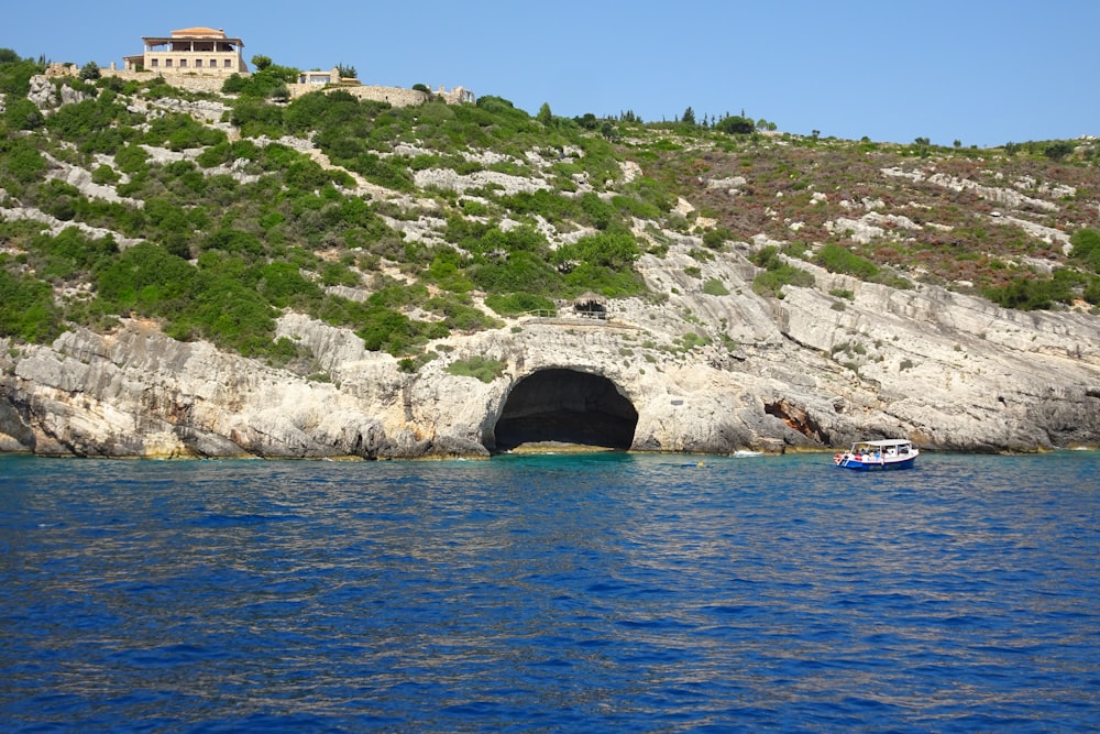 a boat in a body of water near a mountain