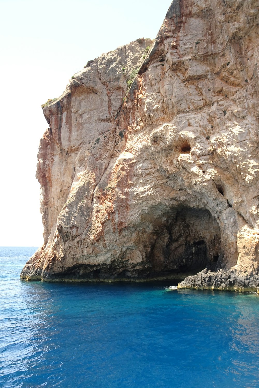 a large rock formation next to a body of water