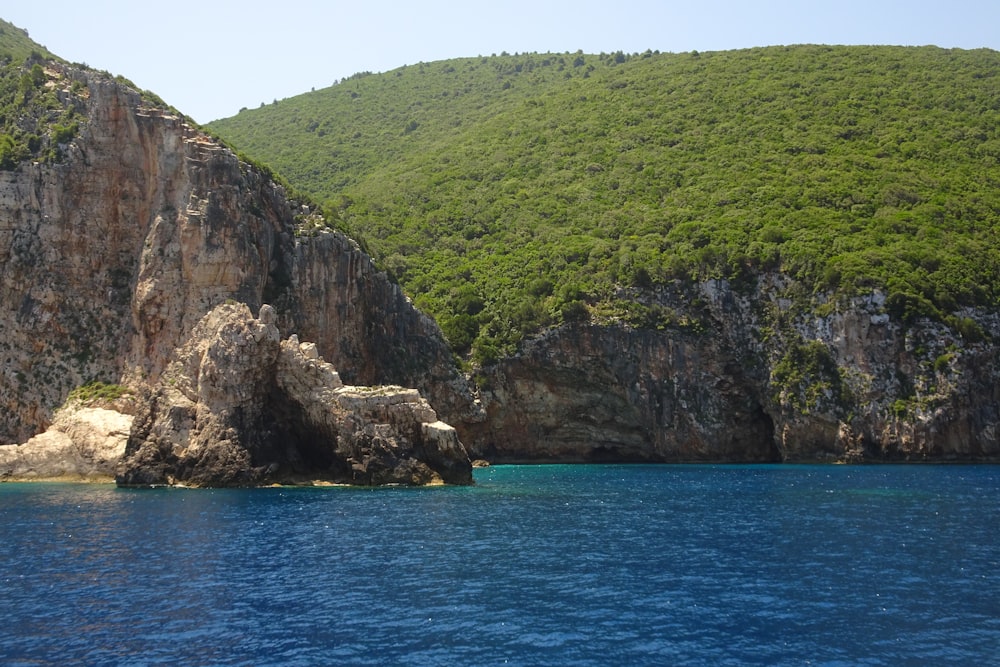 a large rock outcropping in the middle of a body of water