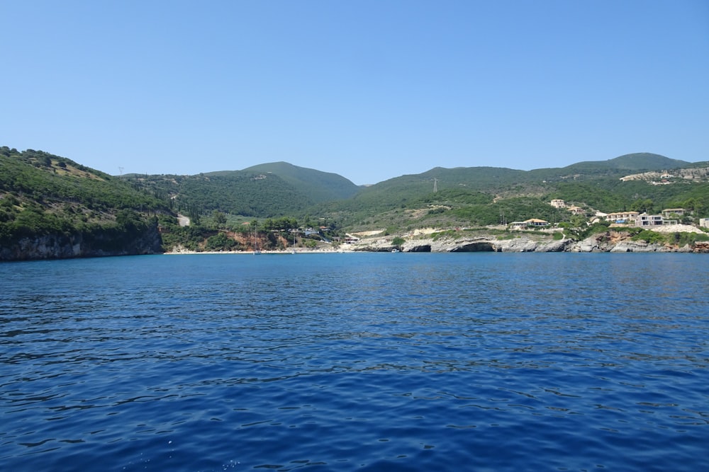 a body of water with mountains in the background