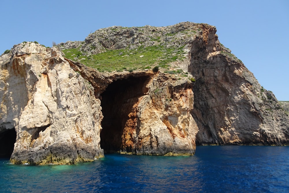 a rocky outcropping in the middle of a body of water