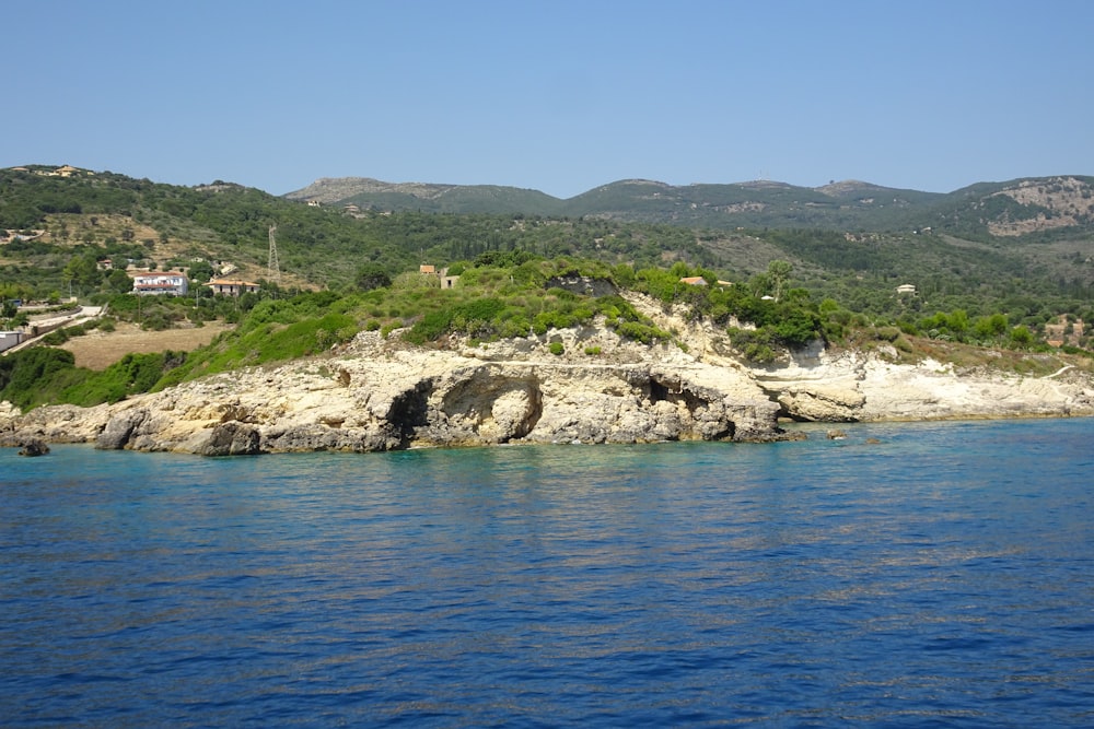 a large body of water with a mountain in the background