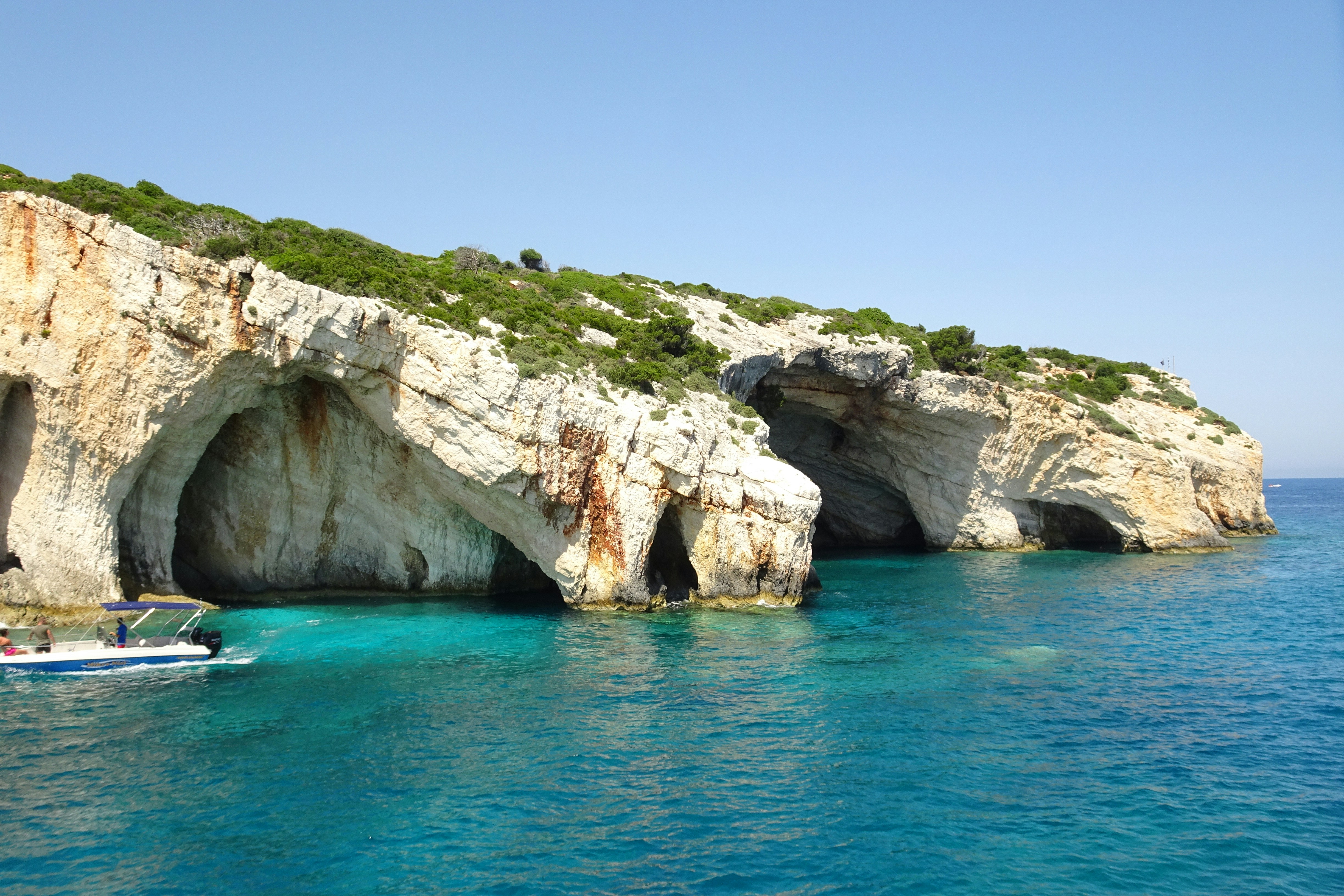 a boat in a body of water near a cliff, Zakynthos Landscape Coast - Greek Island