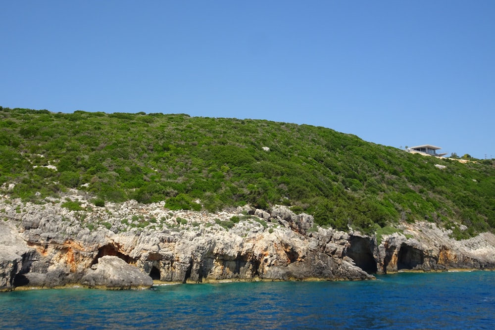 a hill with a blue body of water next to it