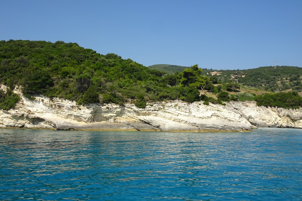 a large body of water with a mountain in the background