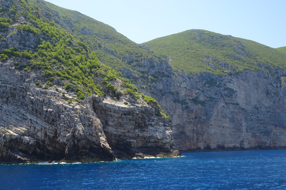 a large body of water with a mountain in the background