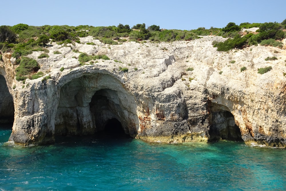 a large body of water next to a rocky cliff