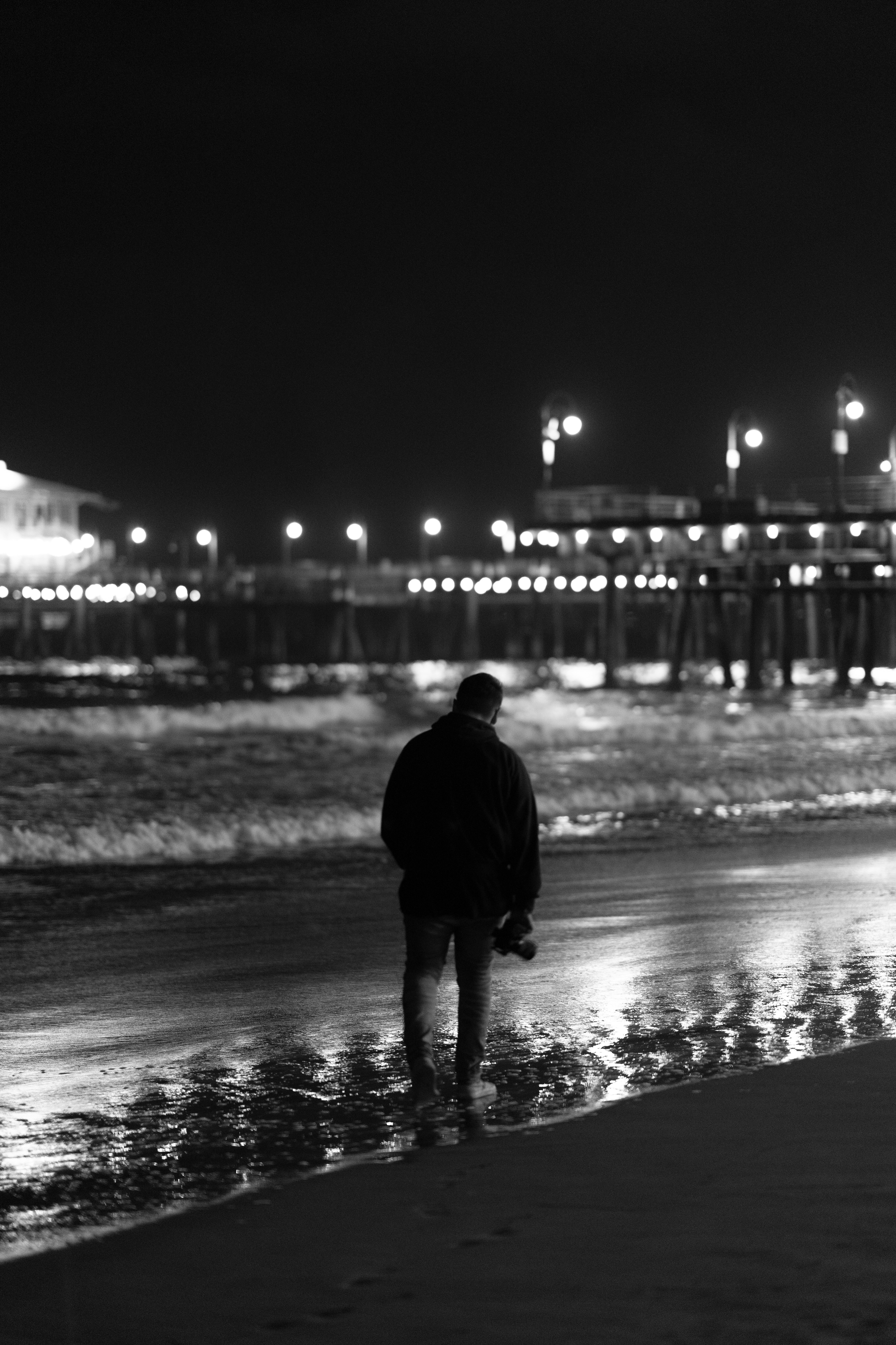 a man standing on a beach next to the ocean