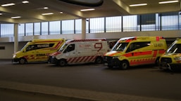 a group of ambulances parked in a parking garage