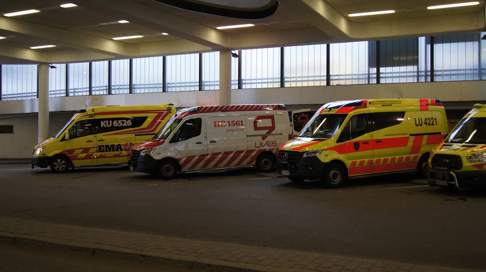 a group of ambulances parked in a parking garage