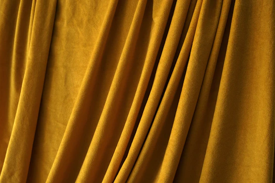 a close up of a curtain with yellow fabric