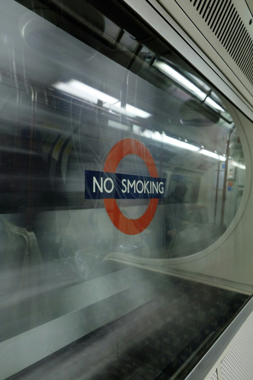 Un letrero que dice no fumar al costado de un tren
