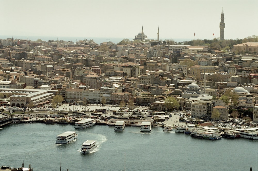 a harbor filled with lots of boats next to a city