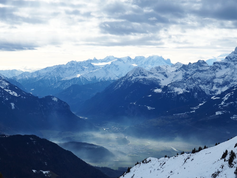 a view of a mountain range with snow on it