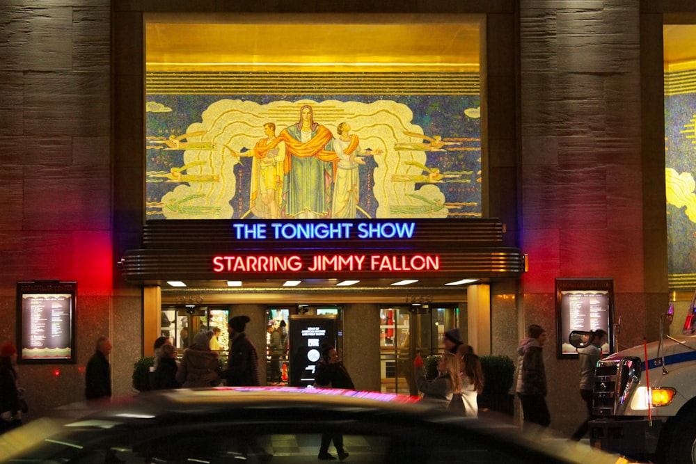 a crowd of people standing outside of a building