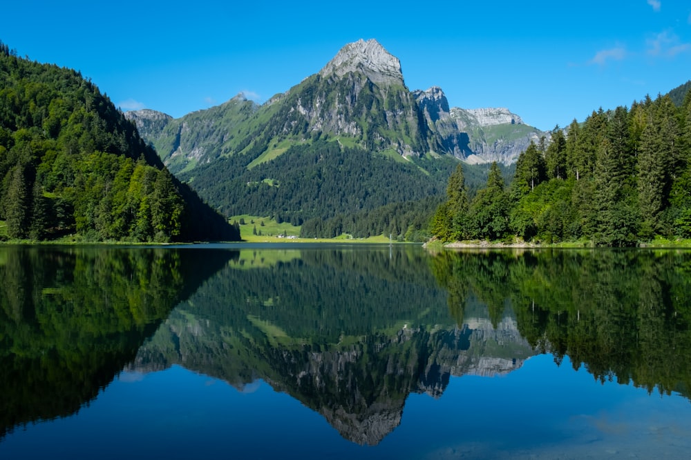 a mountain is reflected in the still water of a lake