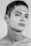 Close-up of a sharp skin fade haircut with a glossy black background and subtle gold highlights.