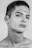 Close-up of a sharp skin fade haircut with a glossy black background and subtle gold highlights.