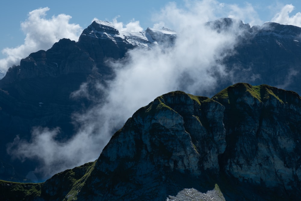 a view of a mountain range with clouds in the sky