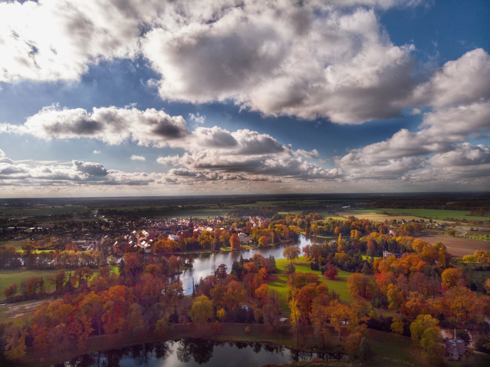 an aerial view of a lake surrounded by trees