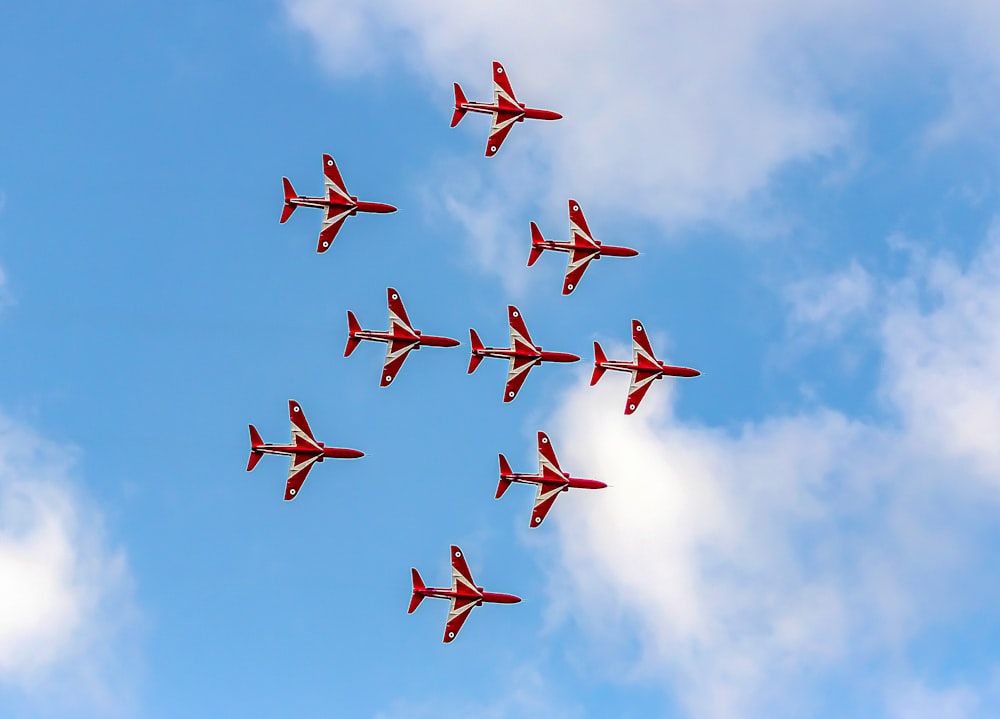 a group of planes flying in formation in the sky