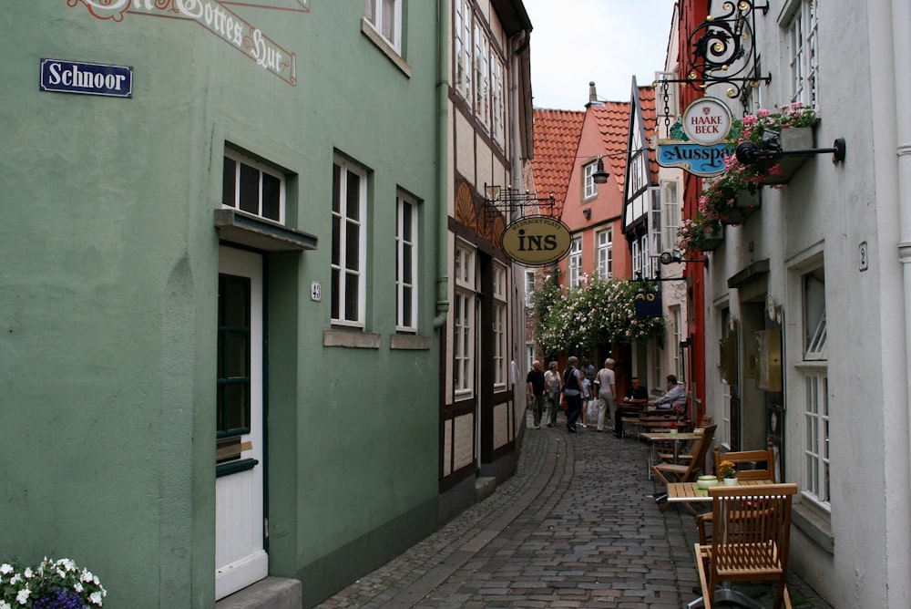 a cobblestone street lined with shops and restaurants