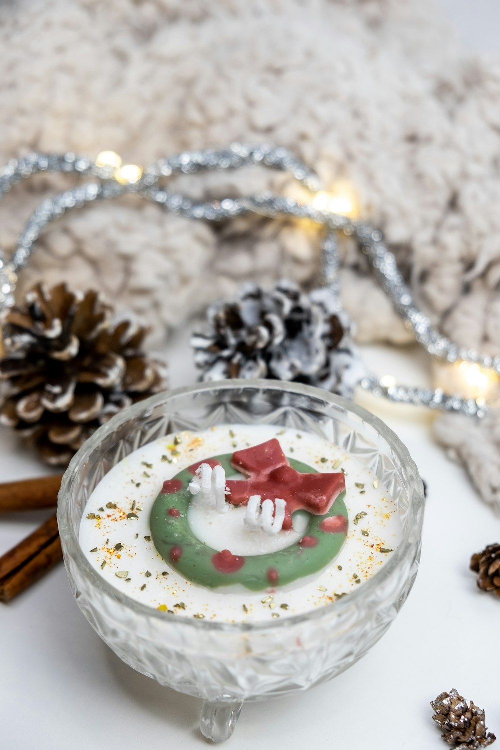 a small glass bowl with a christmas decoration on it