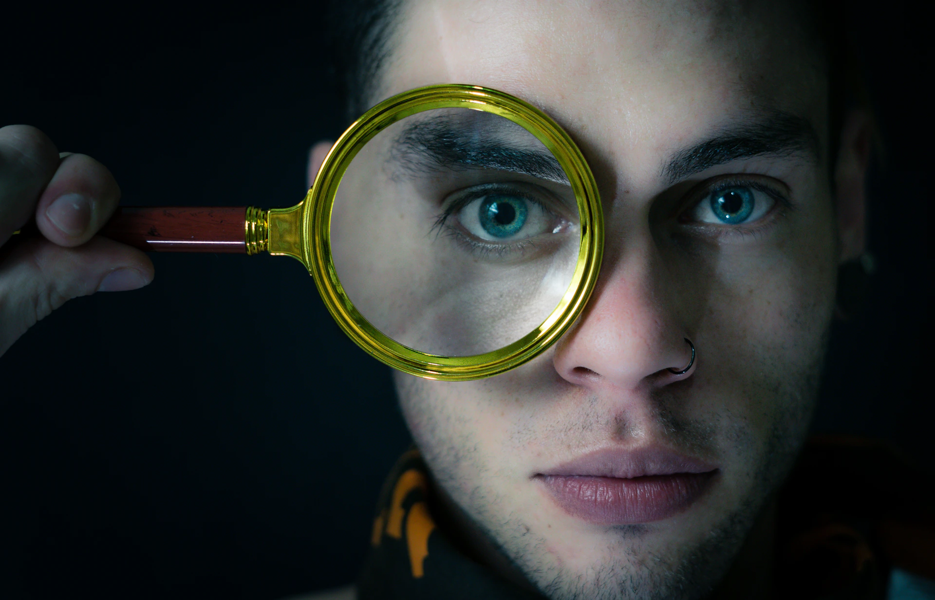 a man looking through a magnifying glass