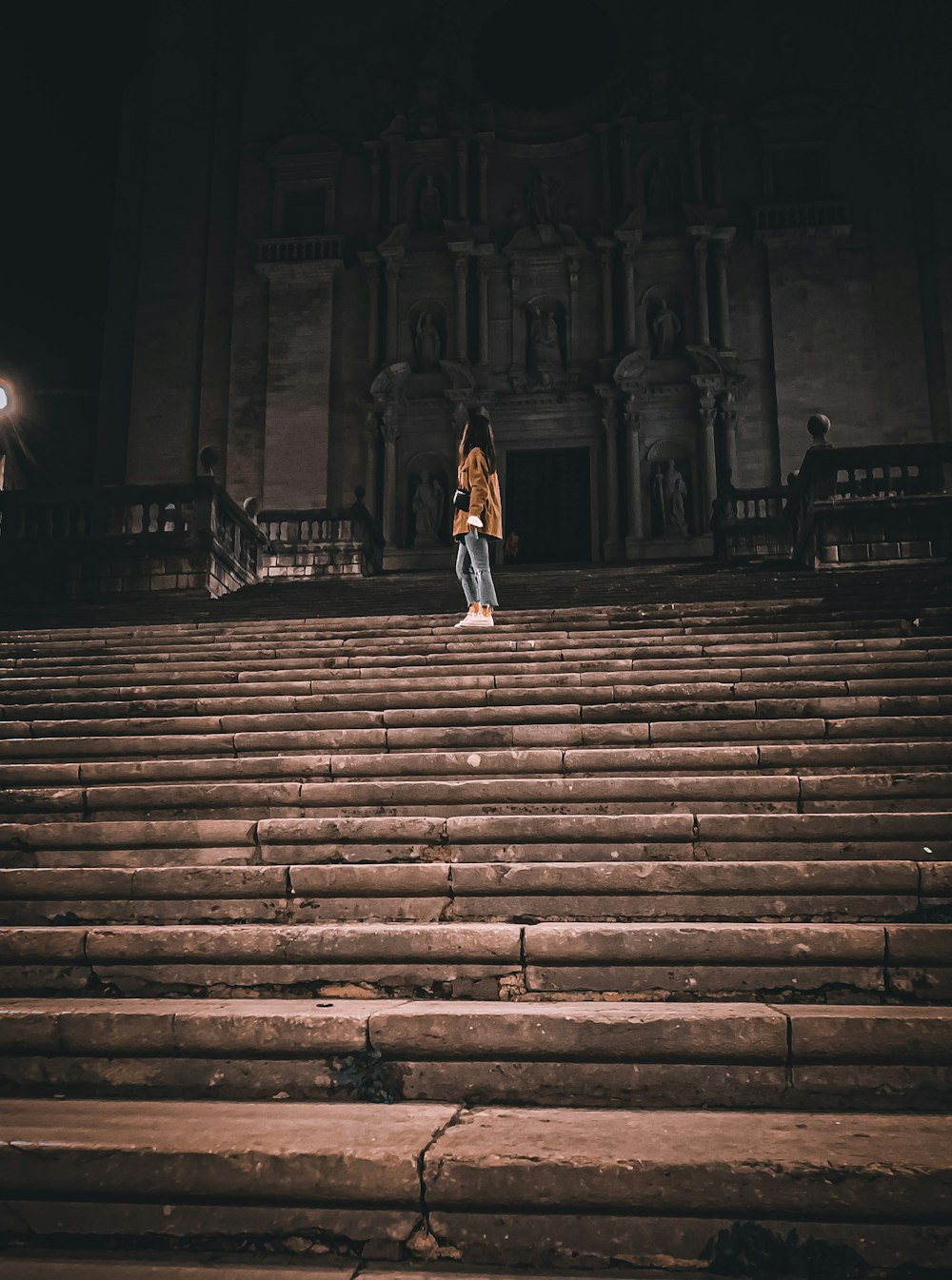 a woman standing on the steps of a building