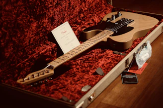 a guitar in a case with a note on it