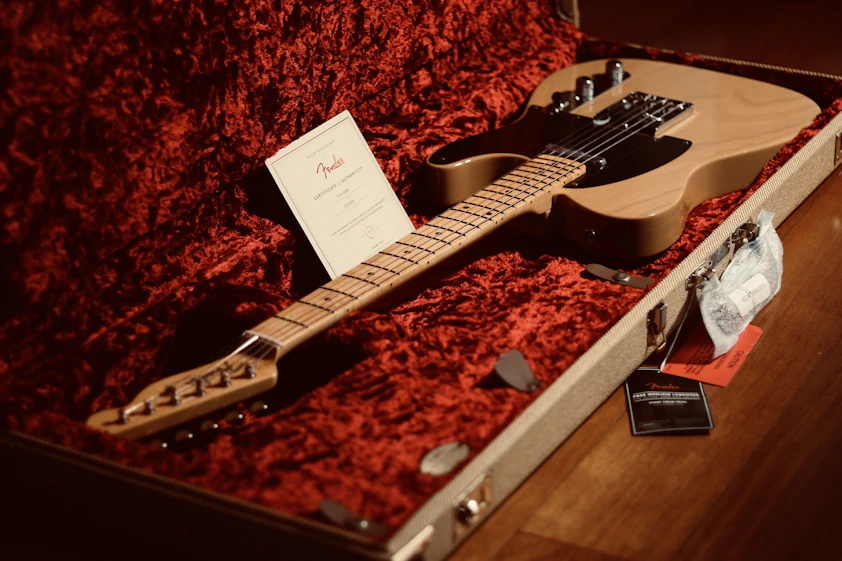 a guitar in a case with a note on it