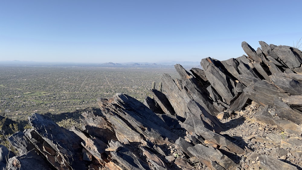 a view of a rocky outcropping with a valley in the distance