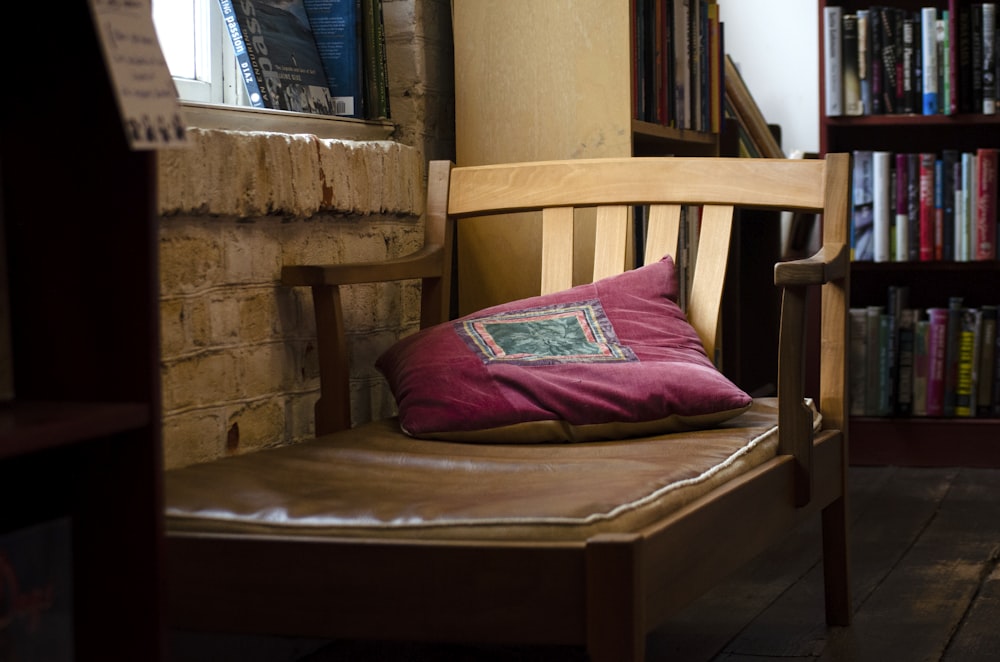 a wooden chair with a pillow on top of it