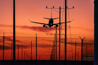 a plane is flying low over a fence