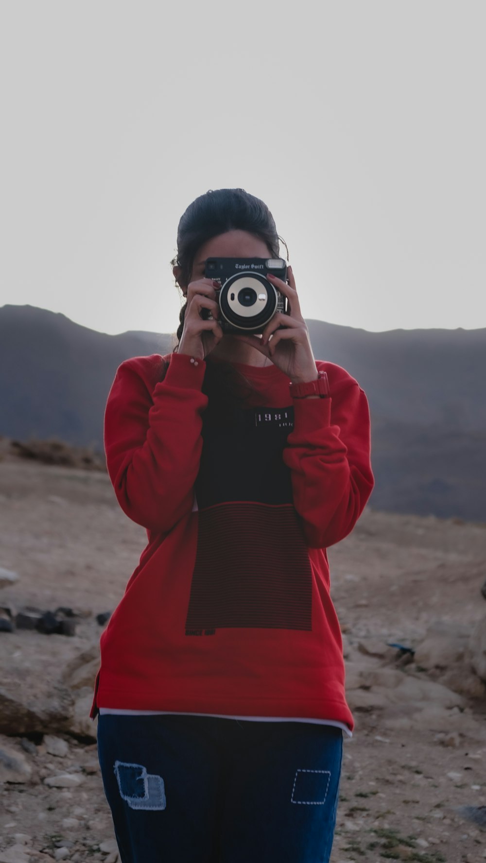 a woman taking a picture of herself with a camera