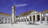 a large building with a clock tower in front of it
