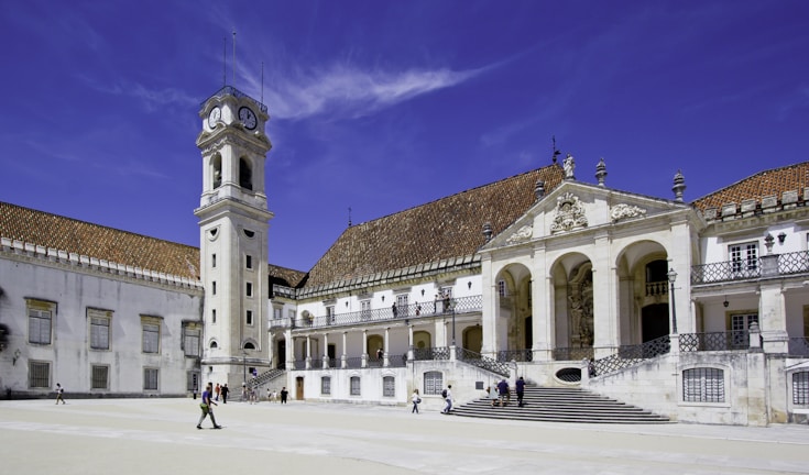 a large building with a clock tower in front of it