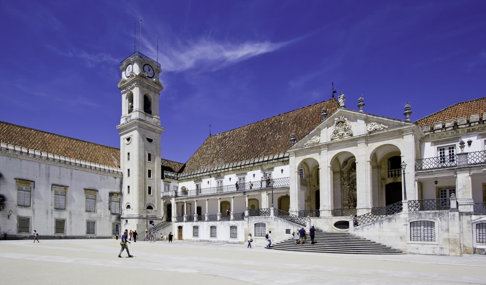 a large building with a clock tower in front of it