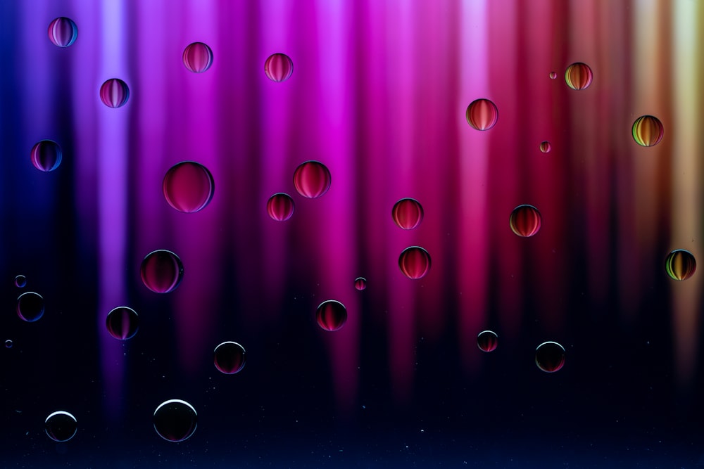 a colorful background with many drops of water