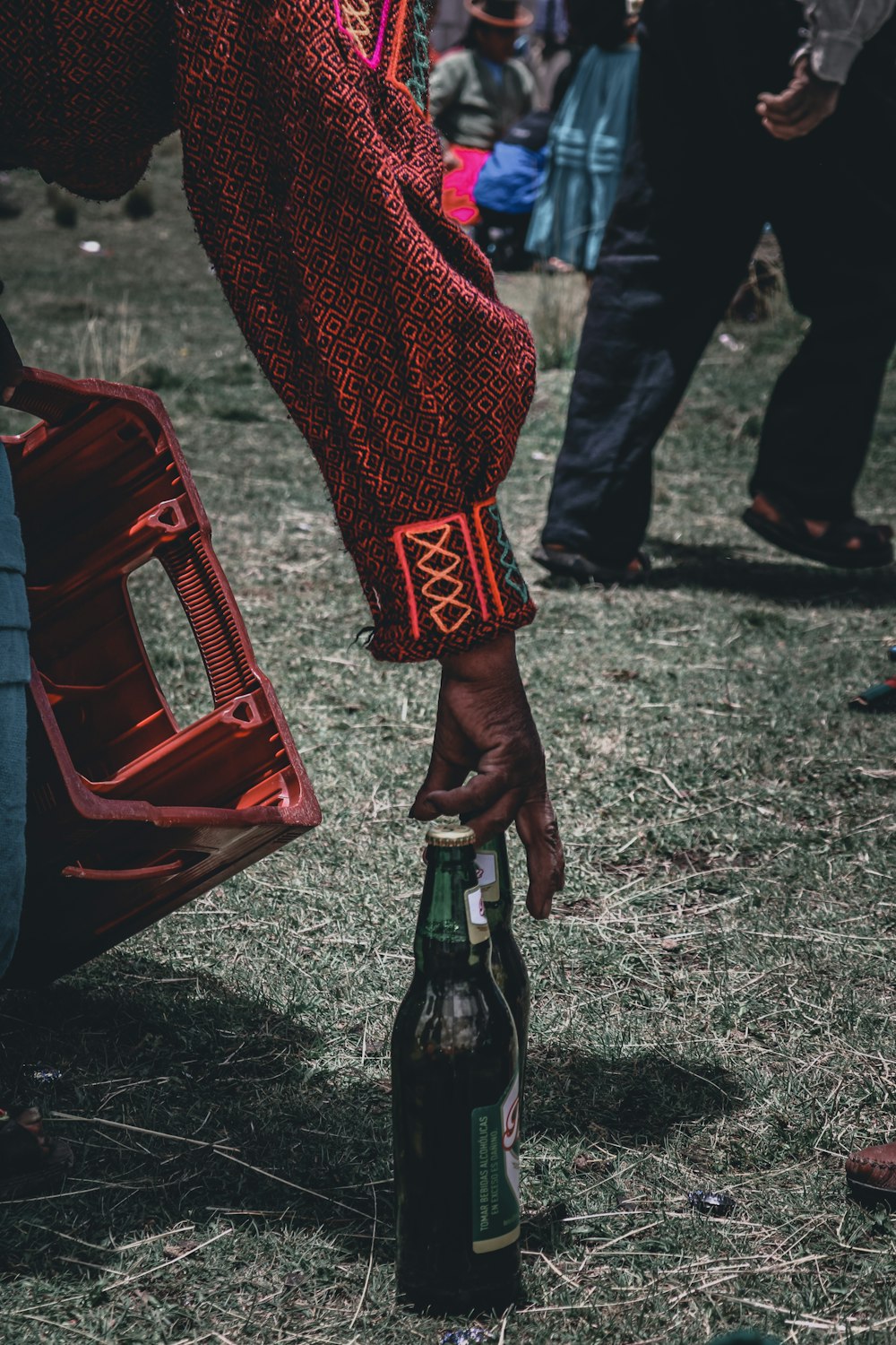a person holding a bottle of beer in their hand