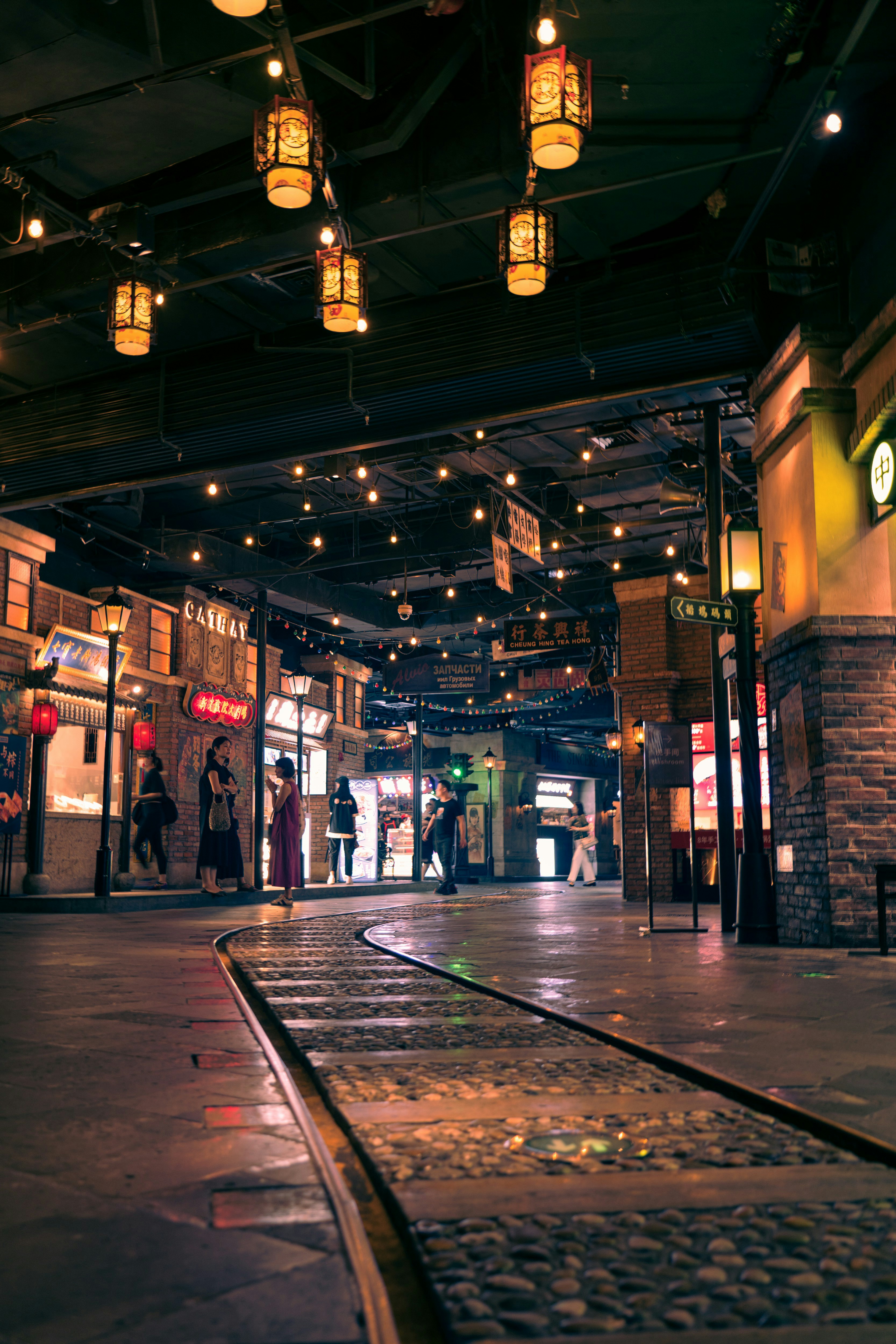 a group of people walking through a shopping mall