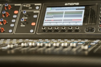 A mixing console with audio tracks displayed.