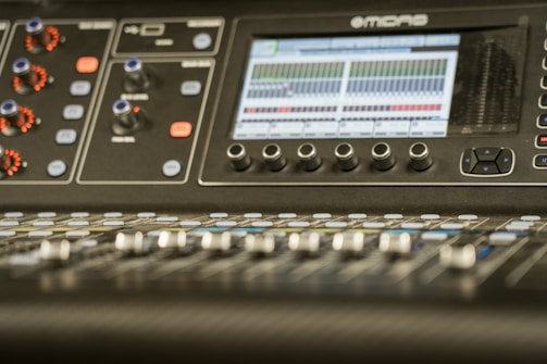 A mixing console with audio tracks displayed.