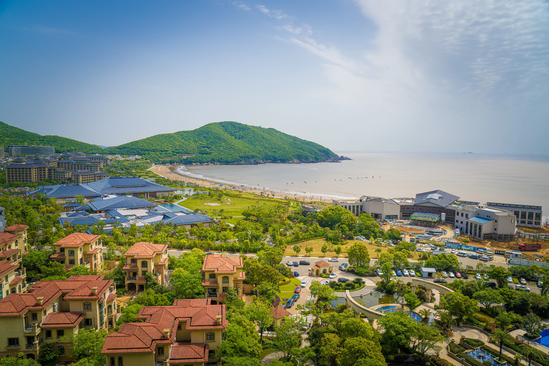 an aerial view of a resort and a body of water