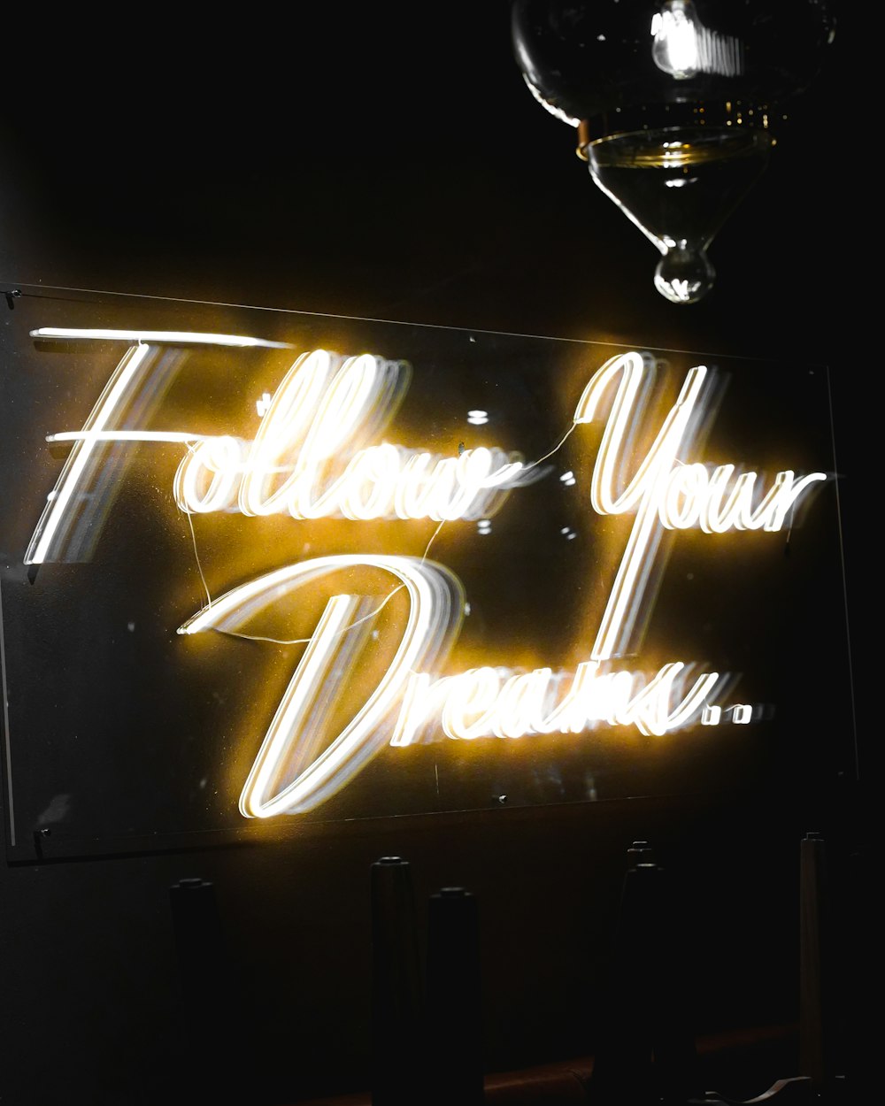 a neon sign that says follow your dreams